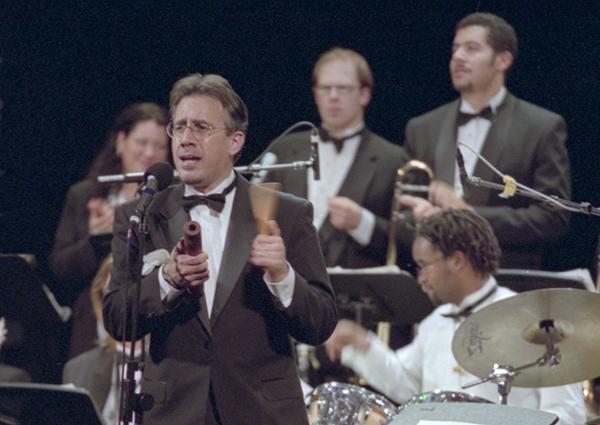 man in tux playing percussion in front of musicians